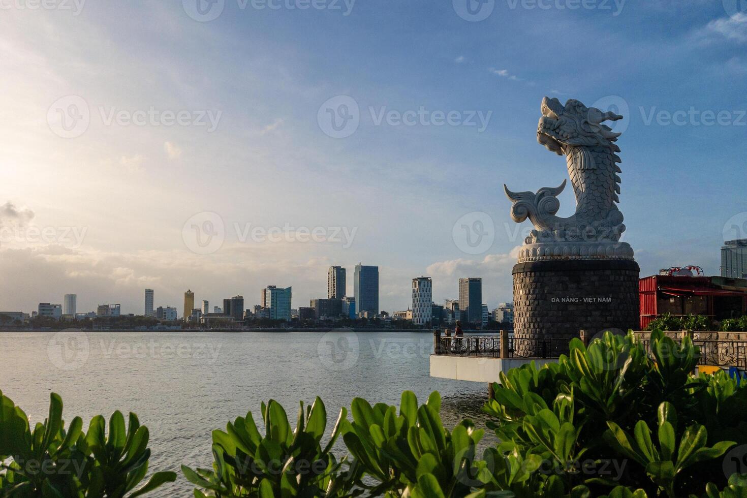 dragon carp statue and the skyline of danang in vietnam photo