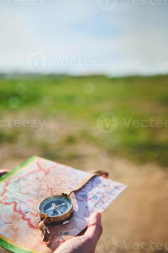 Close-up of a persons hand holding a compass - stock photography concepts photo