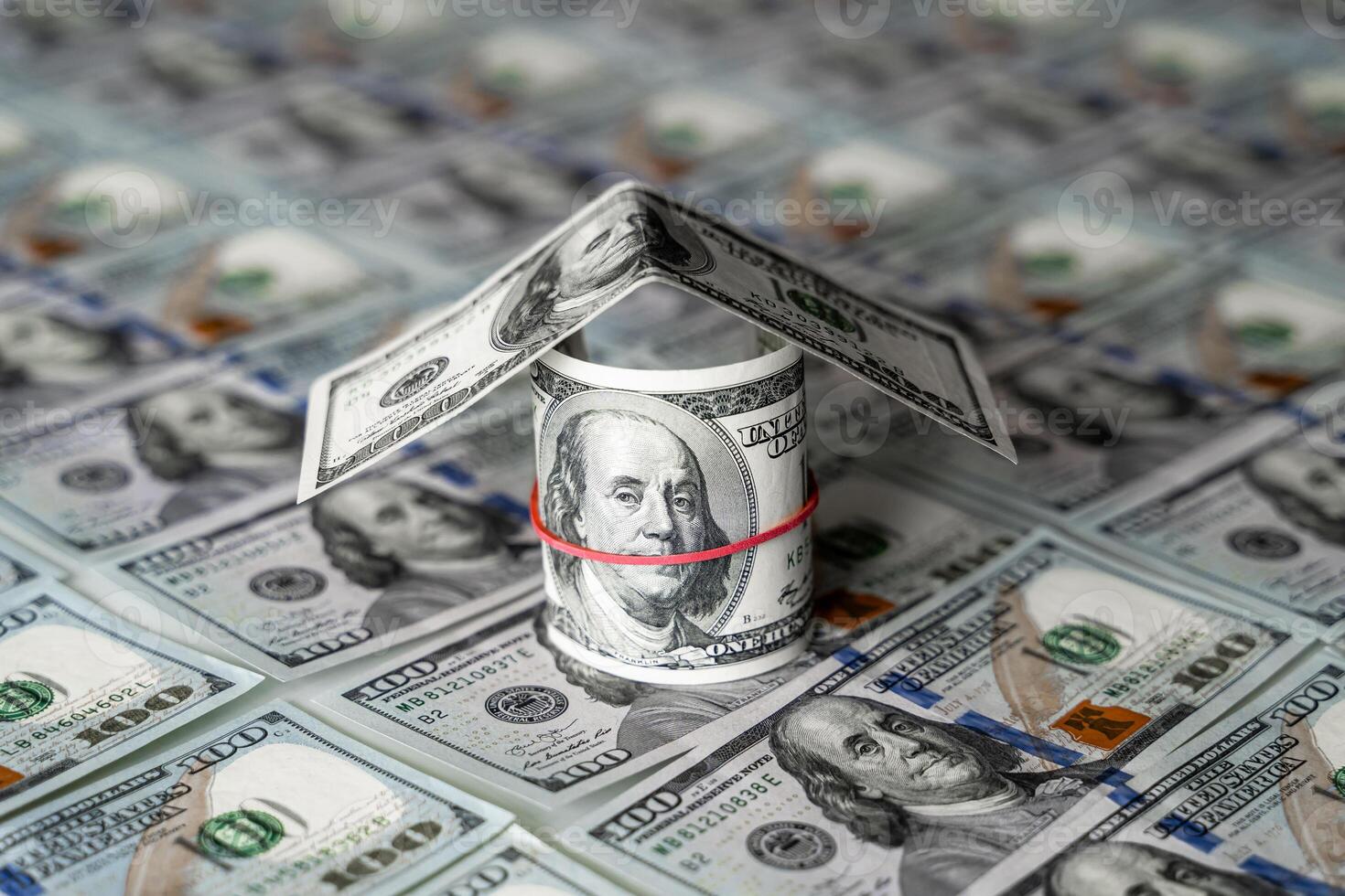 A Creative House Built with Stacked Dollar Bills. A house made out of dollar bills sitting on top of each other photo