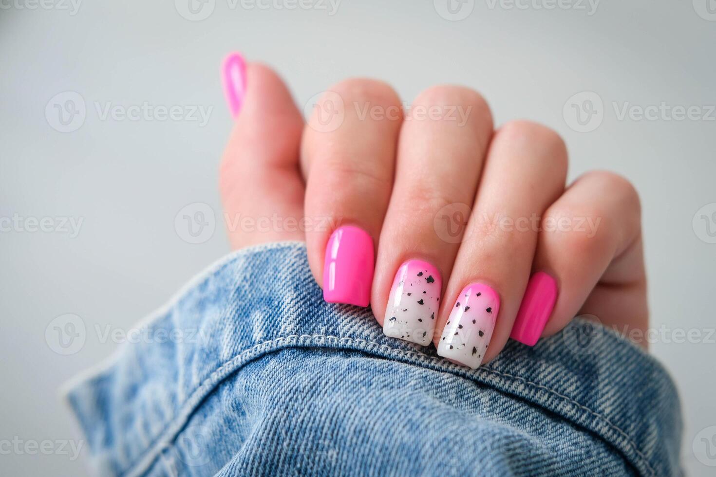 Beautiful female hands with a manicure on a denim background. Shaded nail design. Summer manicure. Copy space. photo