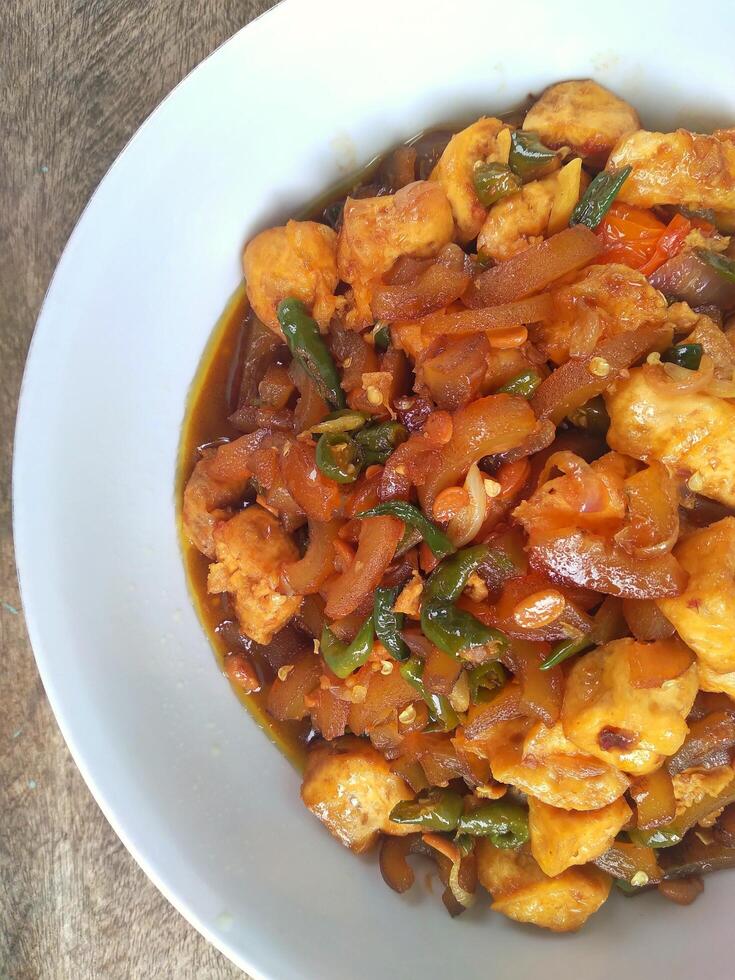Kikil or cow skin with spicy flavors is minang cuisine of West Sumatra, Indonesia. Kikil Cooked using Indonesian herbs, such as red chilies, shallots, garlic, tomatoes, etc. photo