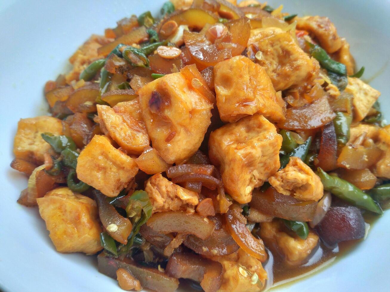 Kikil or cow skin with spicy flavors is minang cuisine of West Sumatra, Indonesia. Kikil Cooked using Indonesian herbs, such as red chilies, shallots, garlic, tomatoes, etc. photo