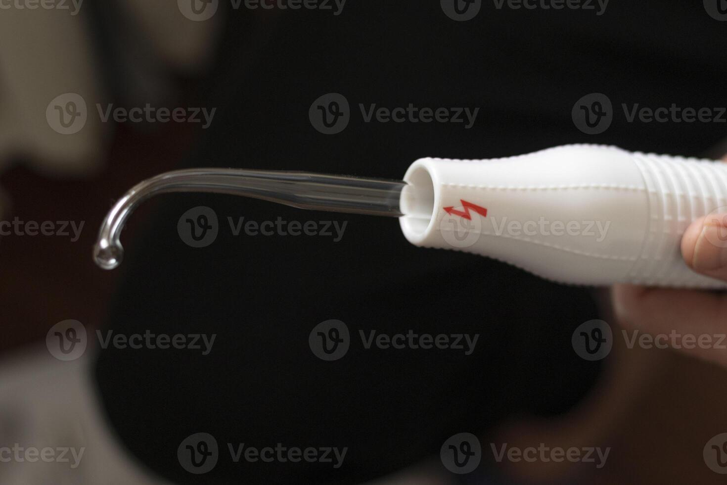 Close up shot of the high frequency comb tool for hair, scalp and skin treatment. Healthcare photo