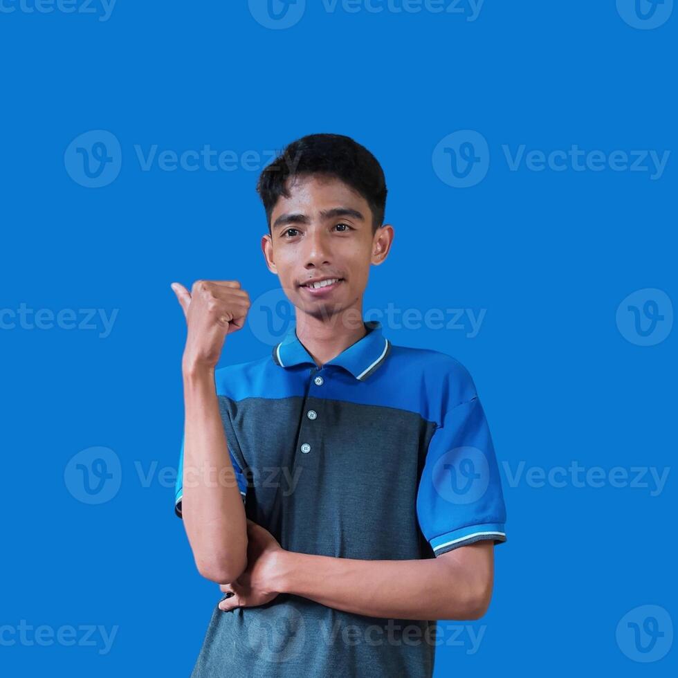 Asian man smiling face with okay gesture, isolated on blue background photo
