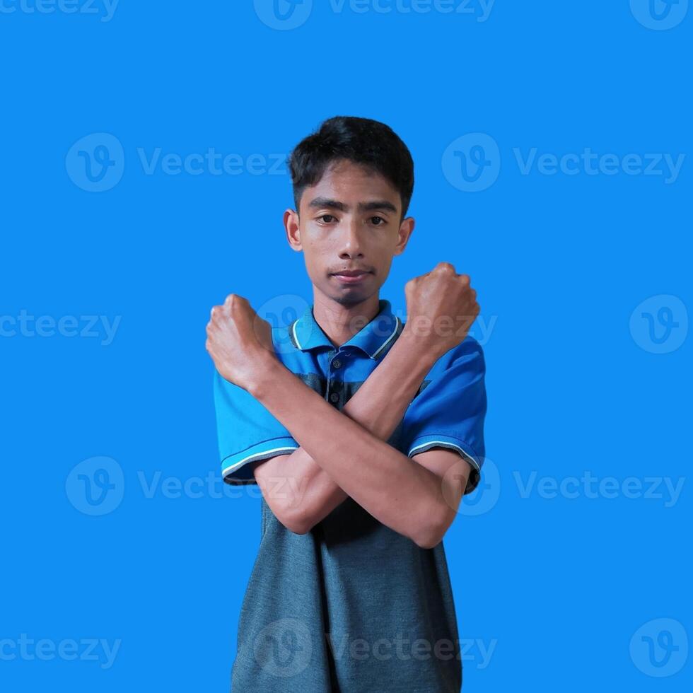 young asian male crossed arms with happy face isolated blue background photo