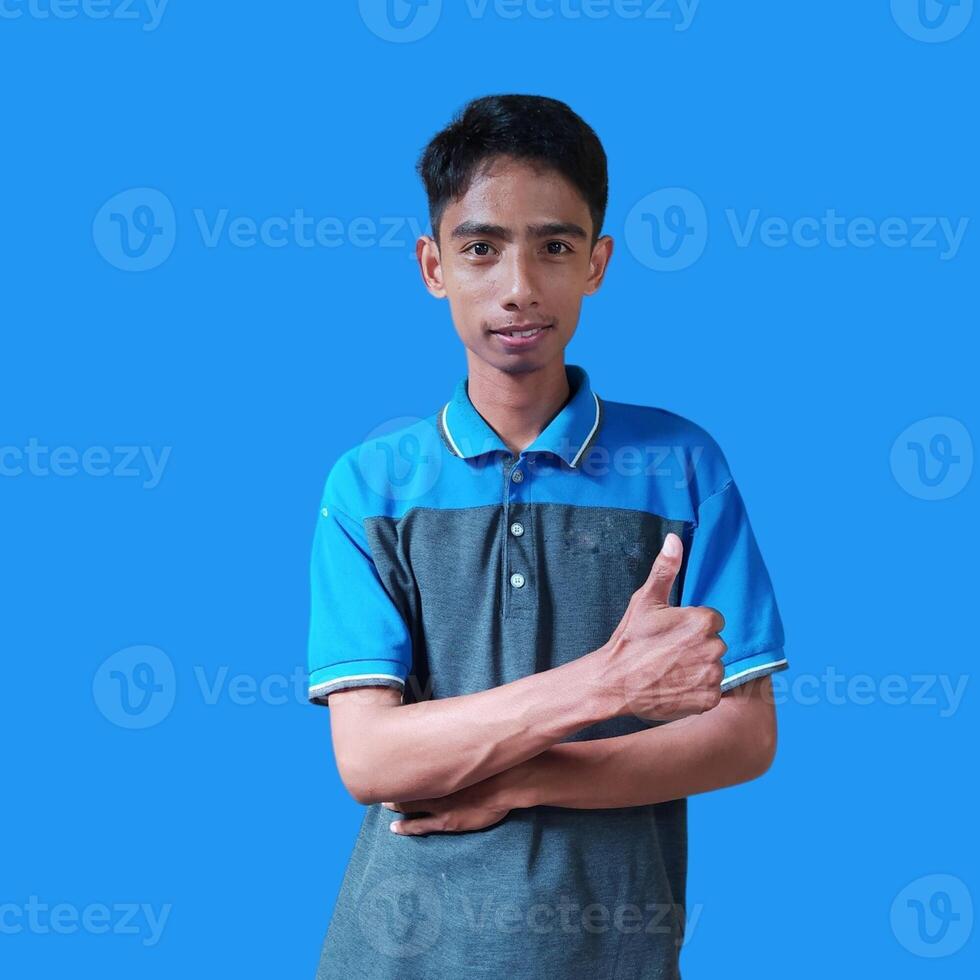 Asian man smiling face with okay gesture, isolated on blue background photo