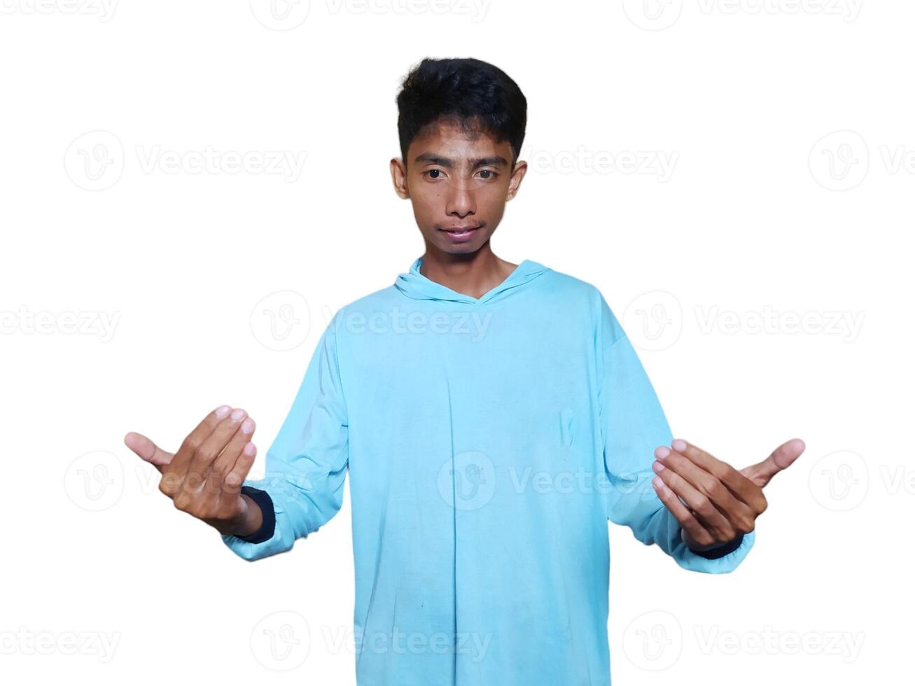 Young Asian man isolated on white background inviting come with hands, glad you came photo