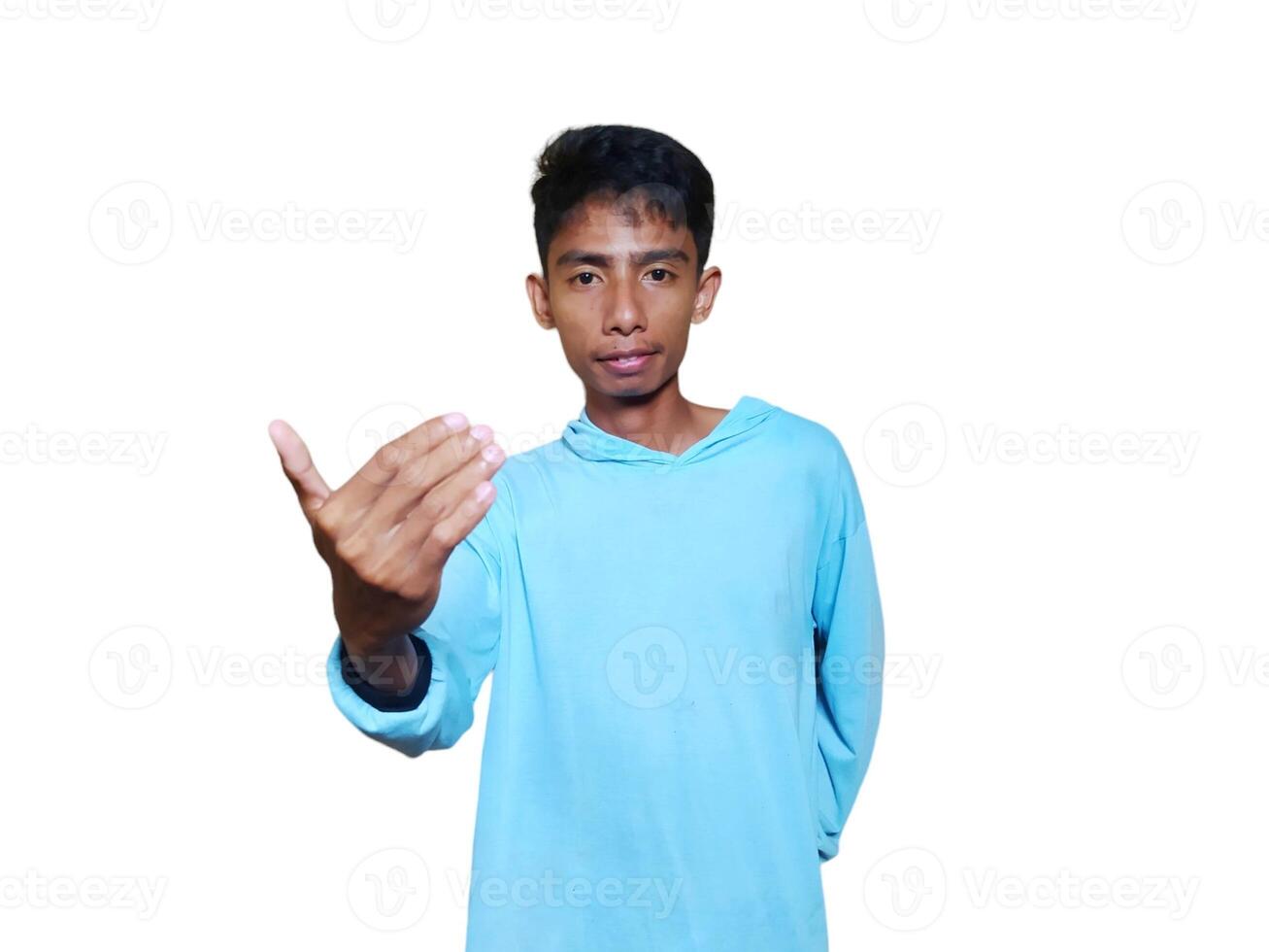 Young Asian man isolated on white background inviting come with hands, glad you came photo