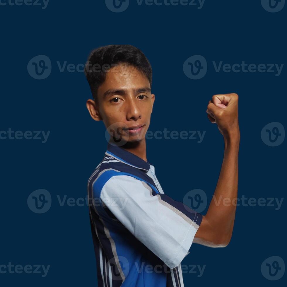 Excited Asian man wearing colorful t-shirt showing strong movement raising arms white background. photo