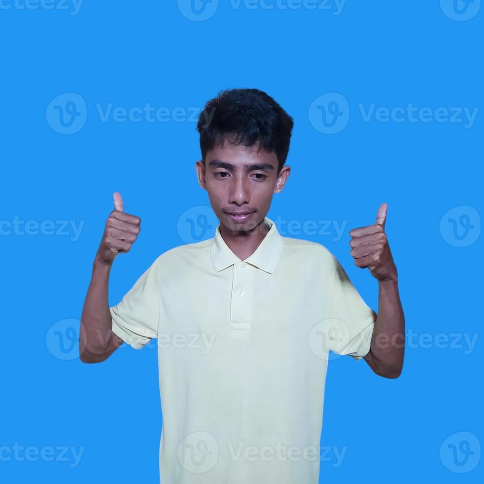 Asian man smiling face with okay gesture, isolated on blue background photo