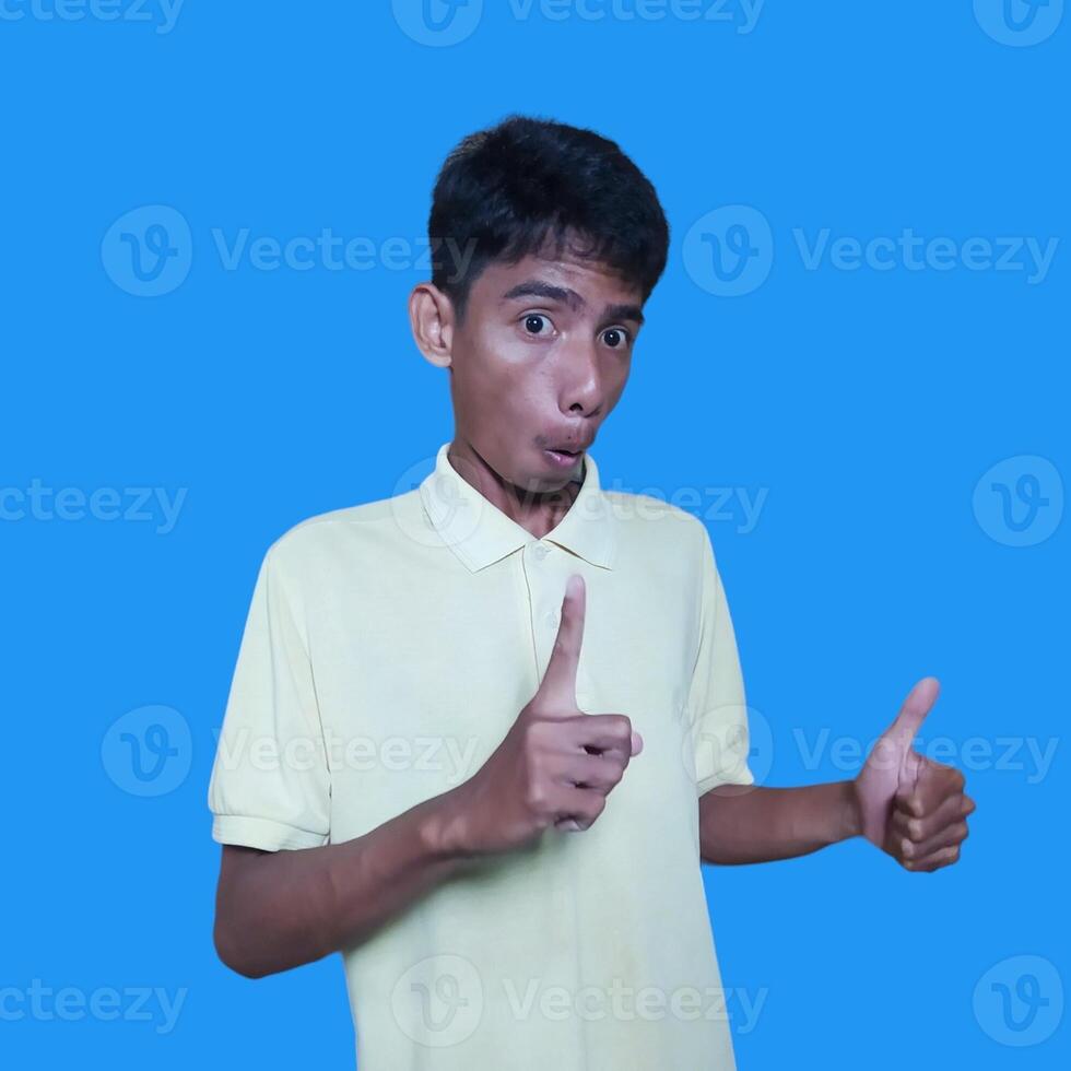 Asian man smiling face with okay gesture, isolated on blue background photo