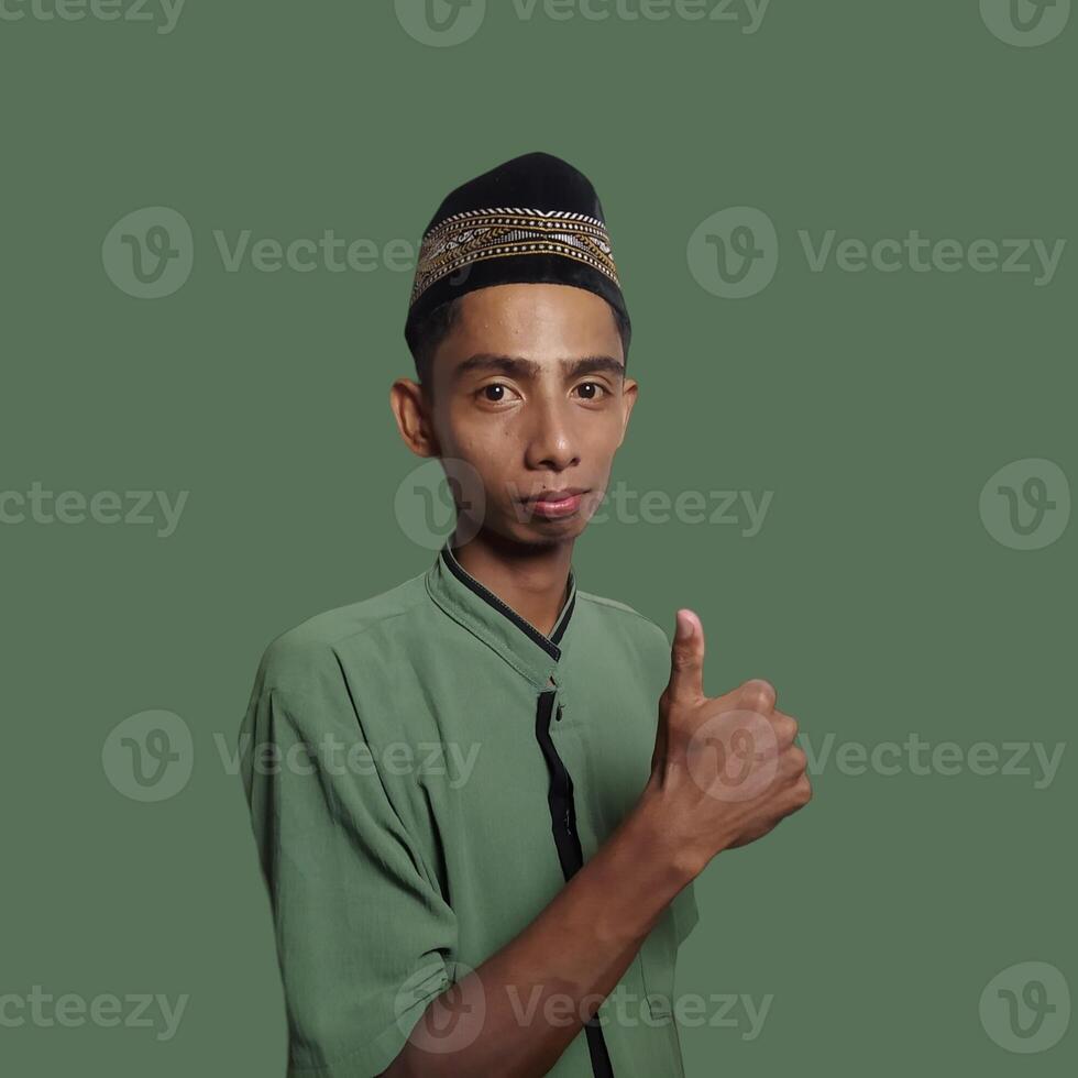 Asian man smiling face with okay gesture, isolated on green background photo