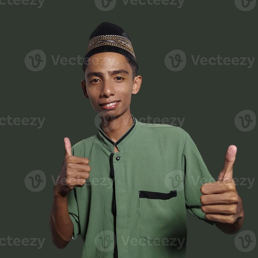 Asian man smiling face with okay gesture, isolated on green background photo