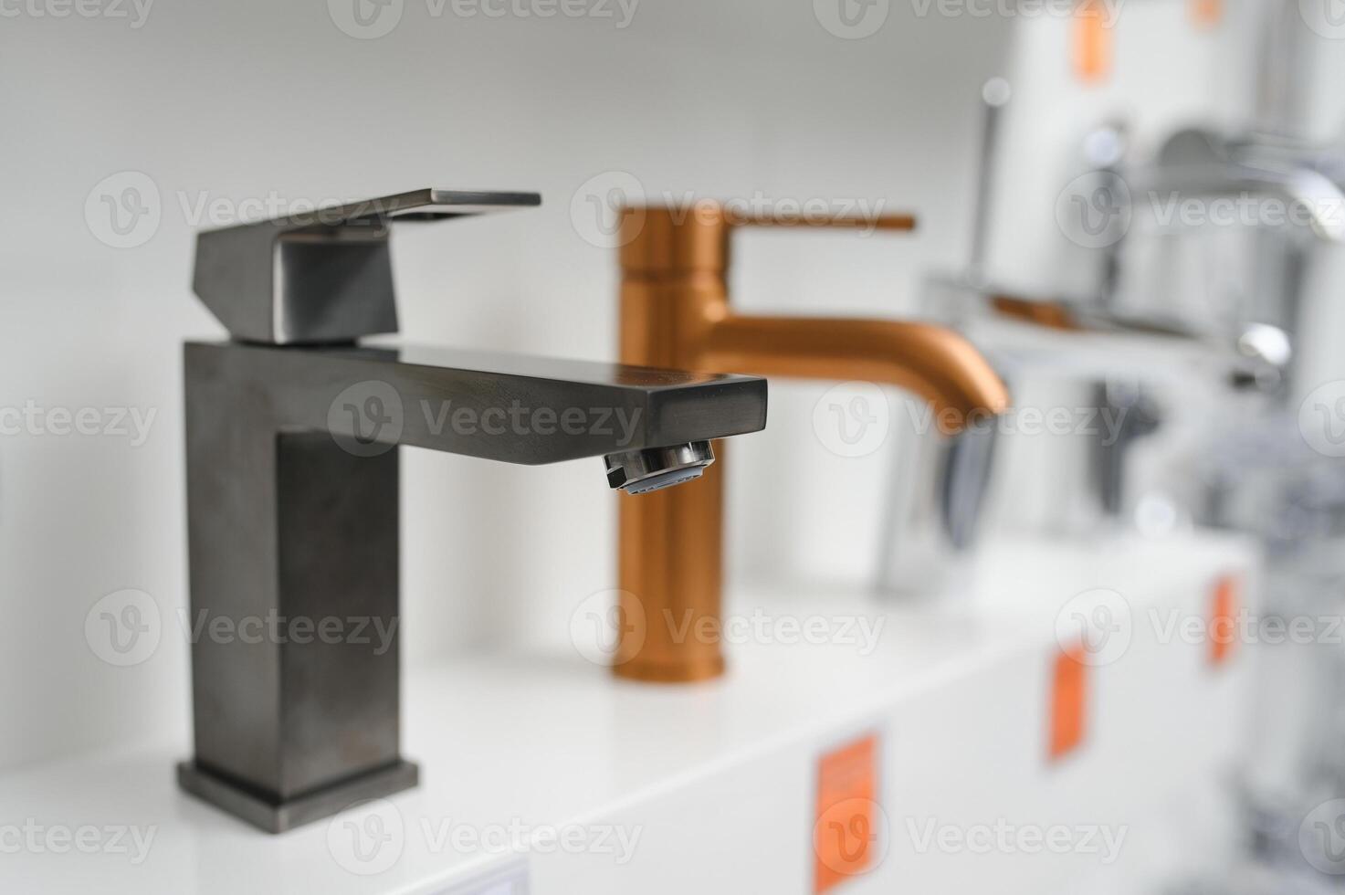 Modern kitchen and bathroom water faucets in the store photo