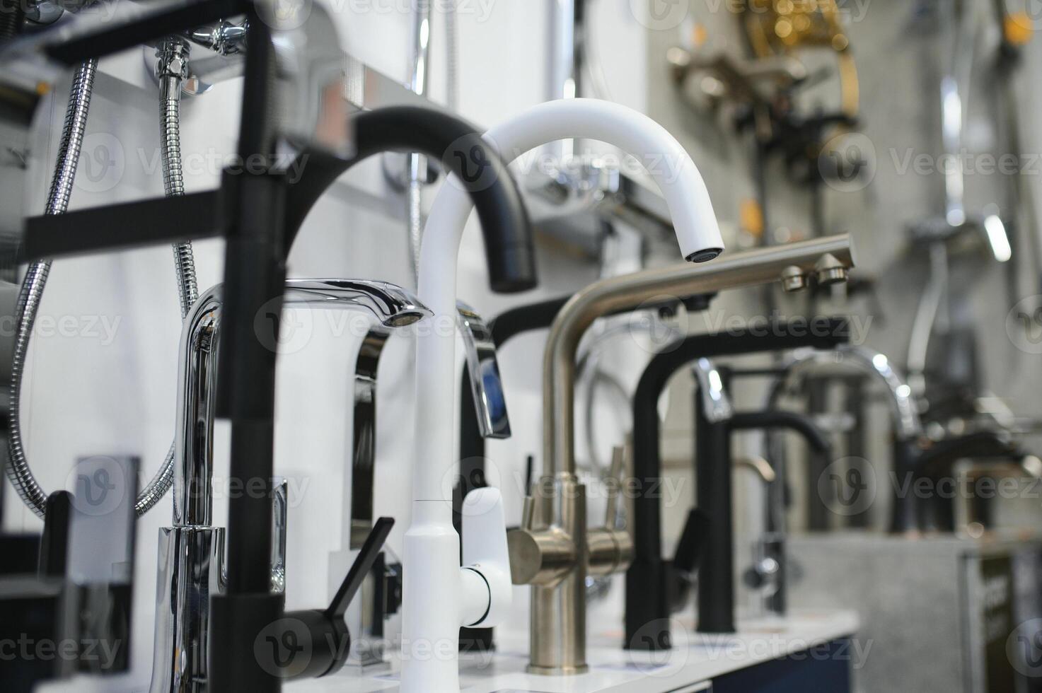Rows of new faucets in plumbing shop photo