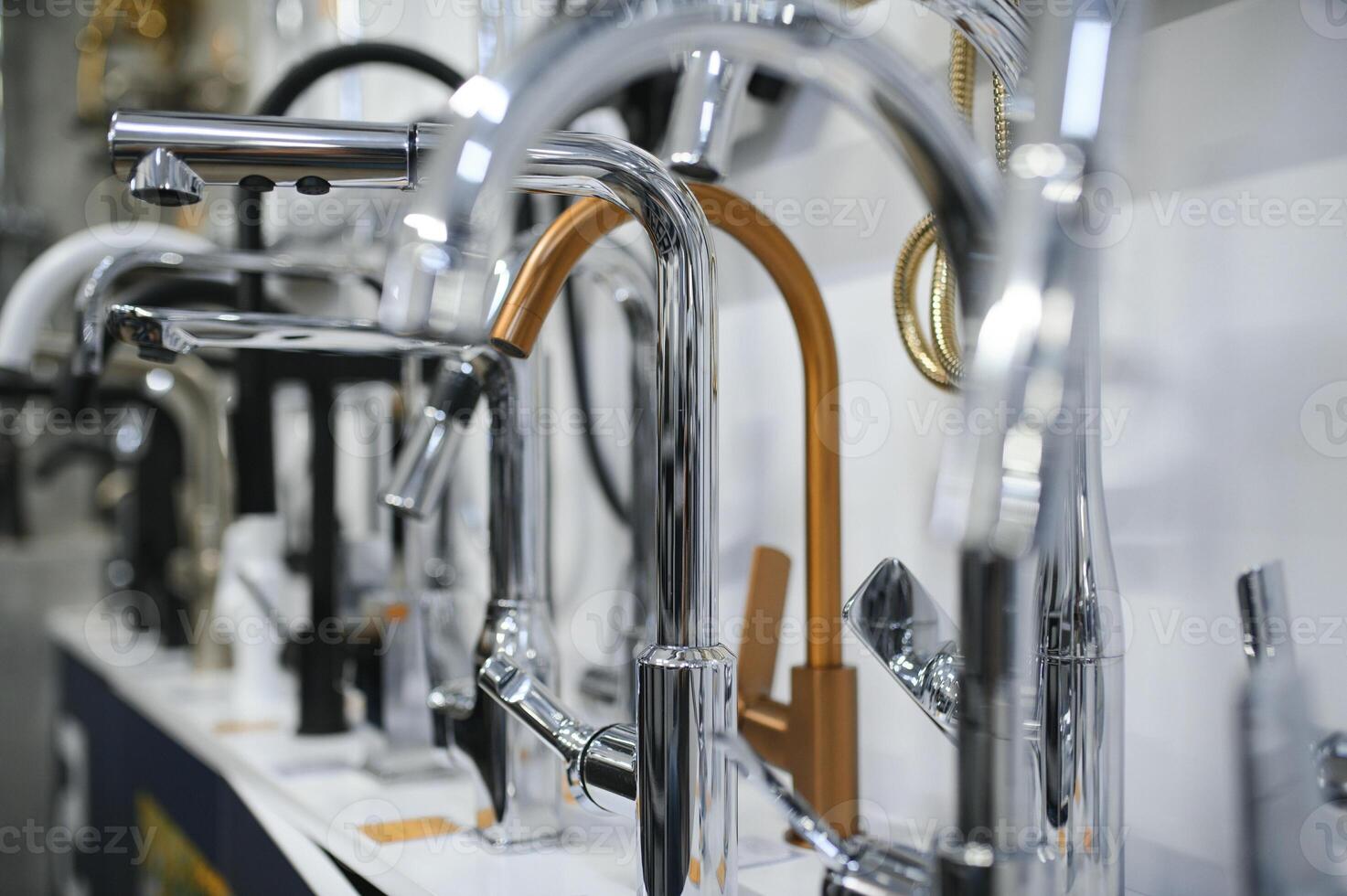 Modern kitchen and bathroom water faucets in the store photo