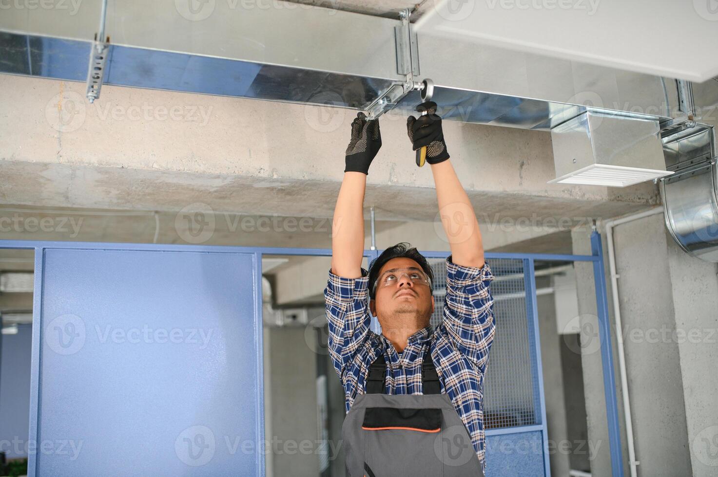 hvac indio trabajador Instalar en pc canalizado tubo sistema para ventilación y aire acondicionamiento. Copiar espacio foto