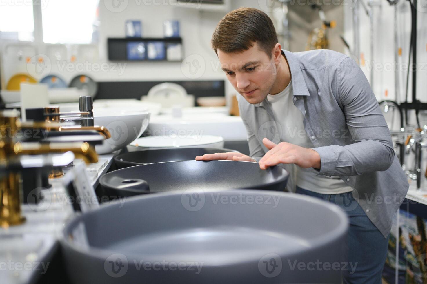Man at the building market looking for sink into their bathroom photo