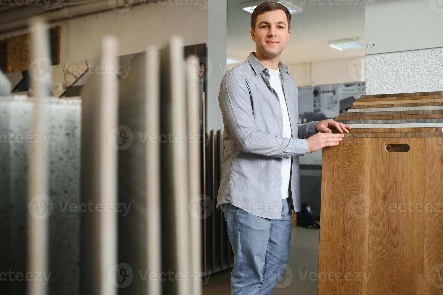 Choosing parquet. Man is in the store of goods for the home photo