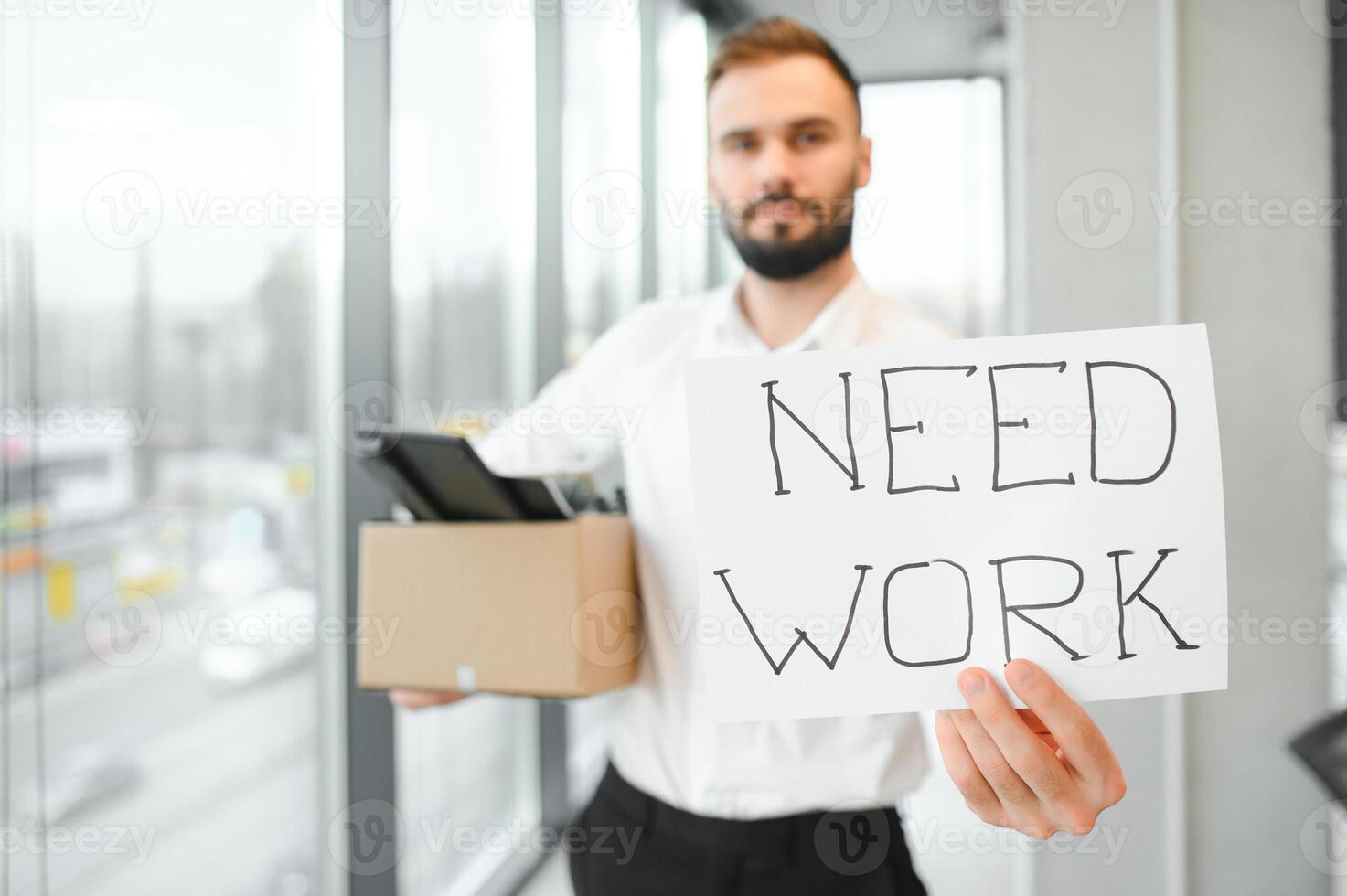 Business, Firing and Job Loss Concept - Sad Fired Male Office Worker With Box of His Personal Stuff photo