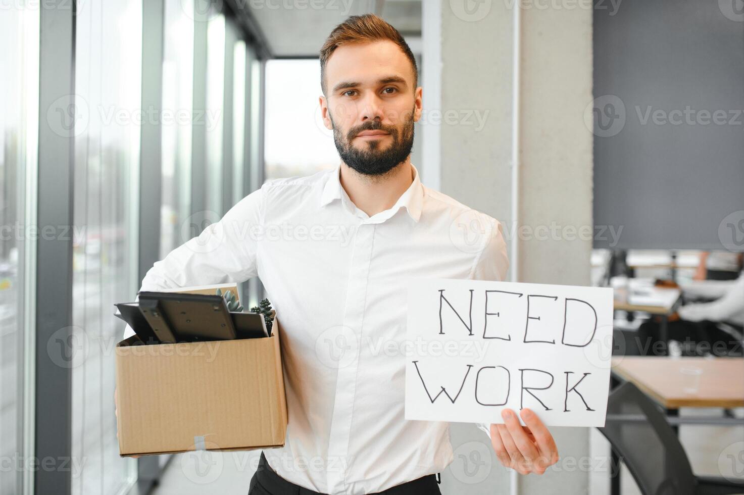 Man by dismissal. Guy lost job. Fired manager in company. Dismissal box in hands of employee. photo