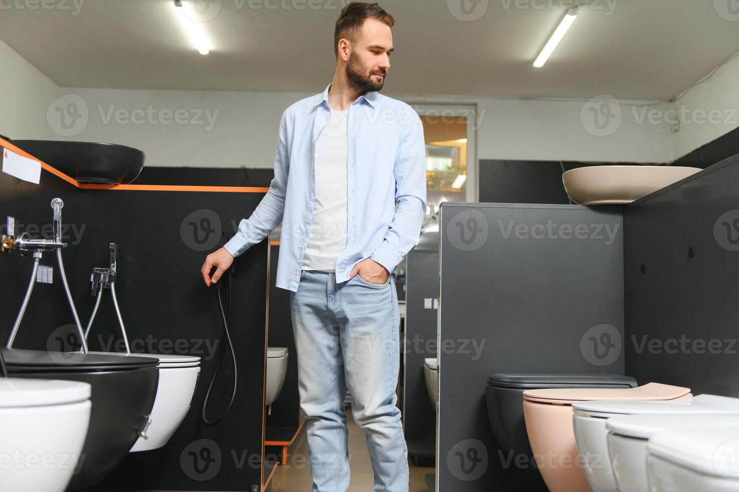 Man choosing home toilet in store photo