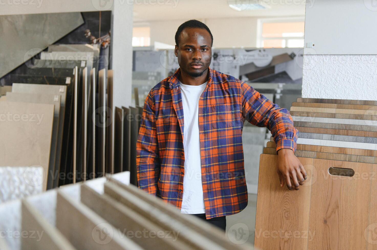 African american man choosing tiles at building market photo