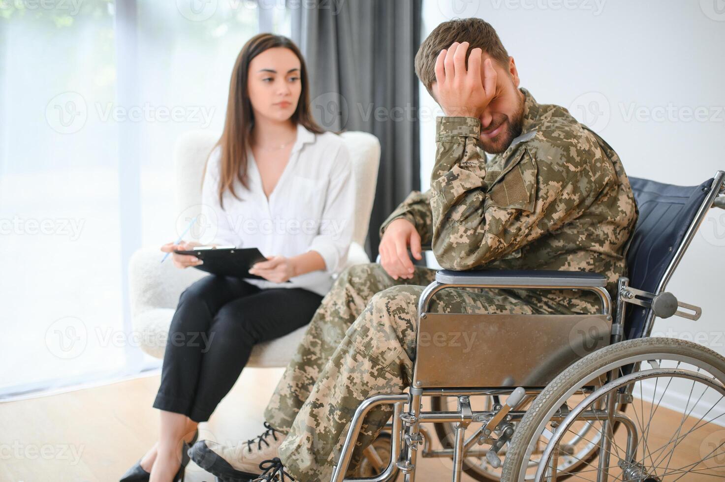 Talking to doctor. Soldier have therapy session with psychologist indoors photo