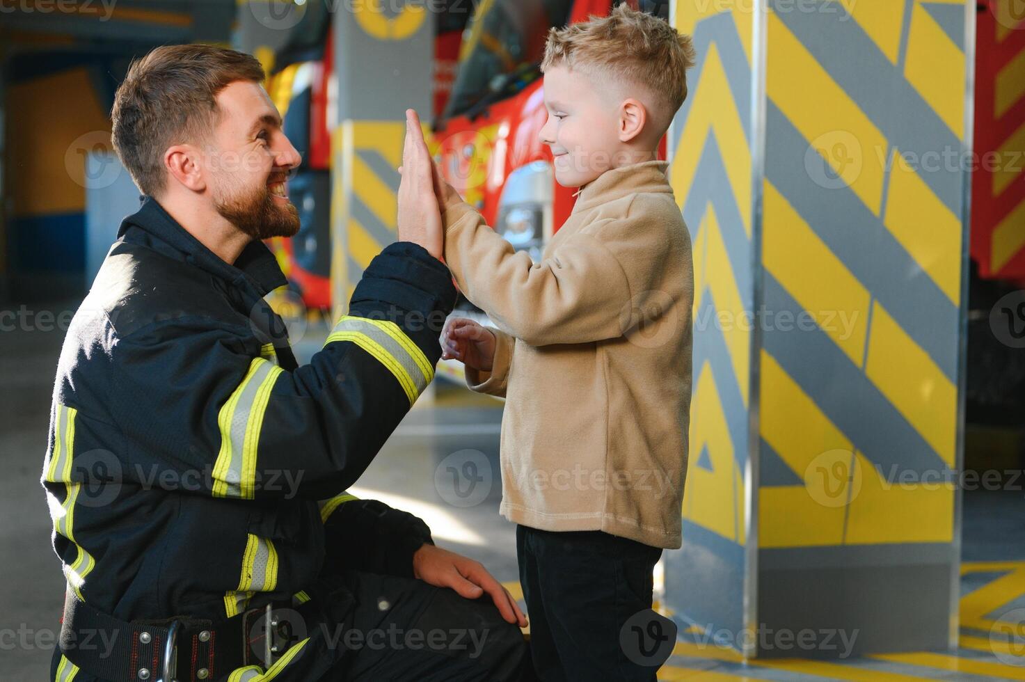 Firefighter holding child boy to save him in fire and smoke,Firemen rescue the boys from fire photo