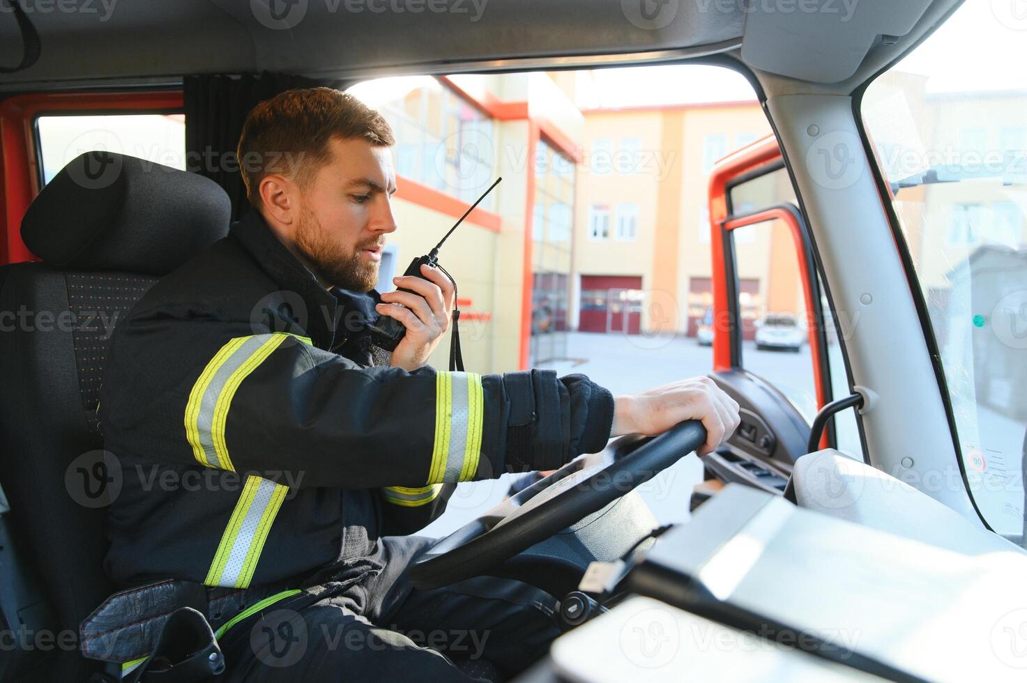 Driver of a fire truck in action photo
