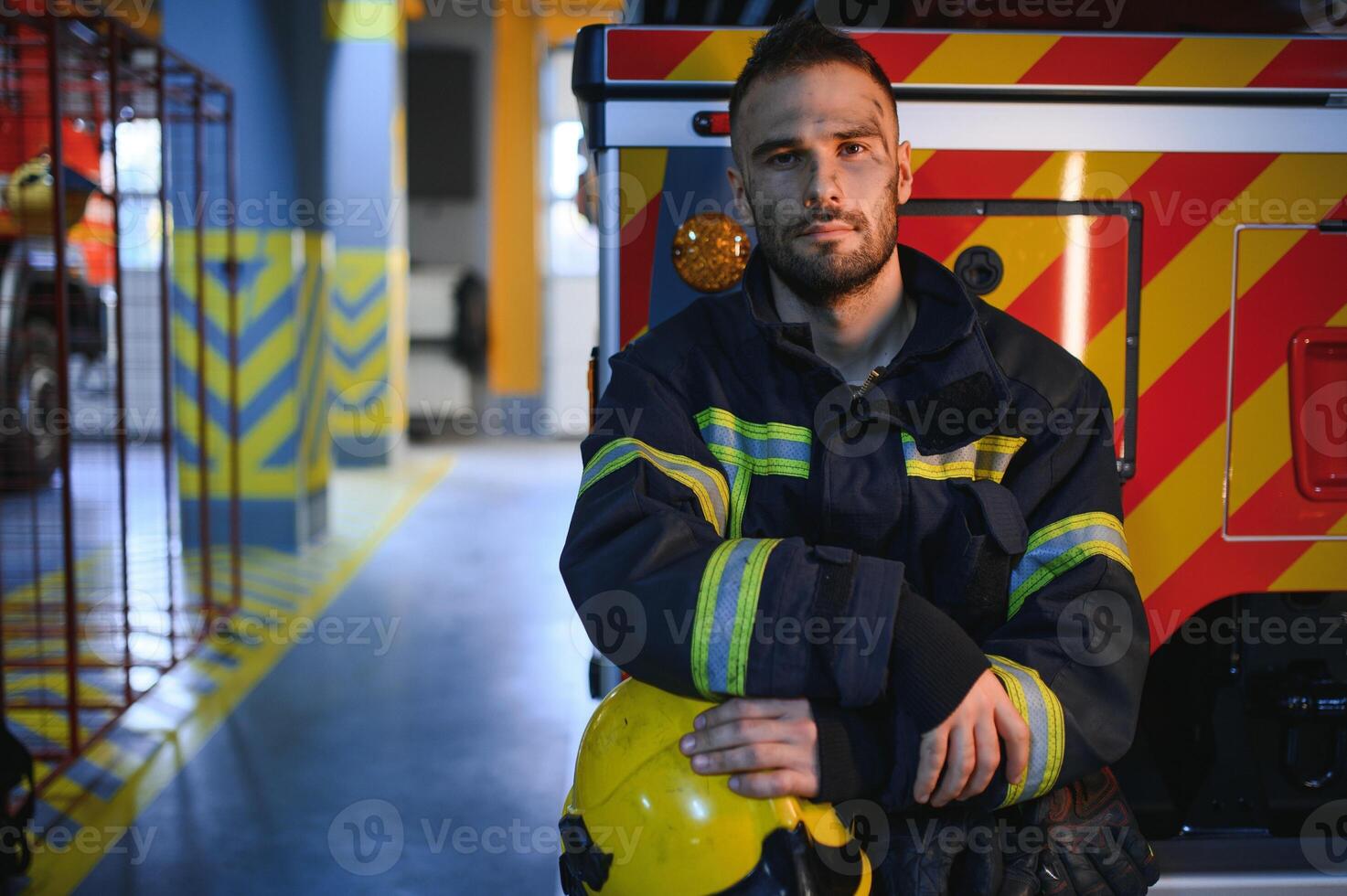 Photo of fireman with gas mask and helmet near fire engine