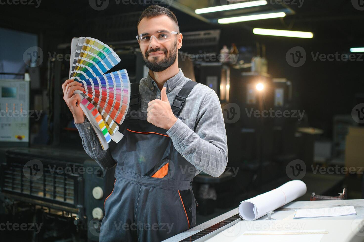 printing house, experimented technician works on UV printer. Production work photo