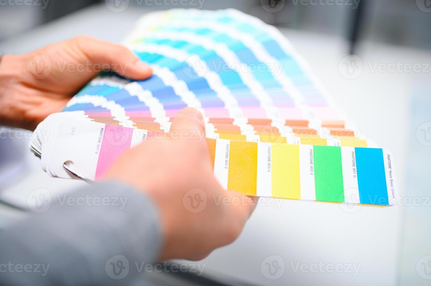 Typographer standing with color swatches at the printing manufacturing photo