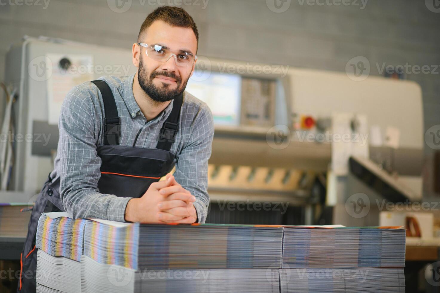 printing house, experimented technician works on UV printer. Production work photo