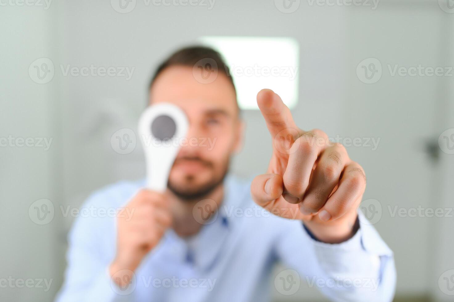 Test of sight. Man is checking his vision indoors in the clinic photo