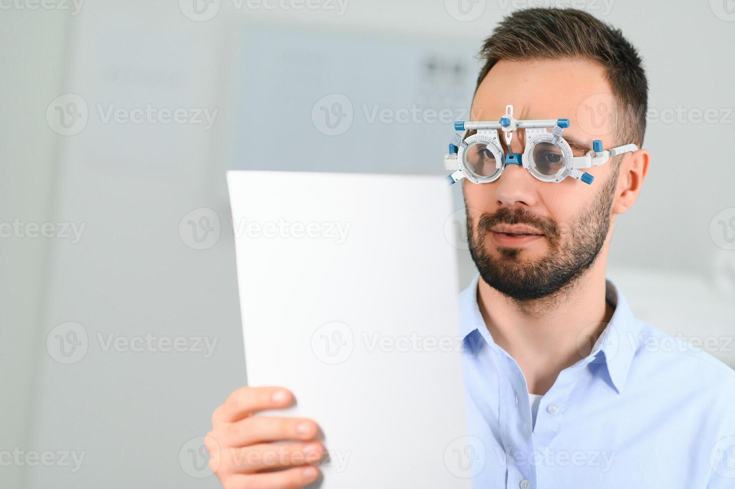 man checking up vision with special ophthalmic glasses photo