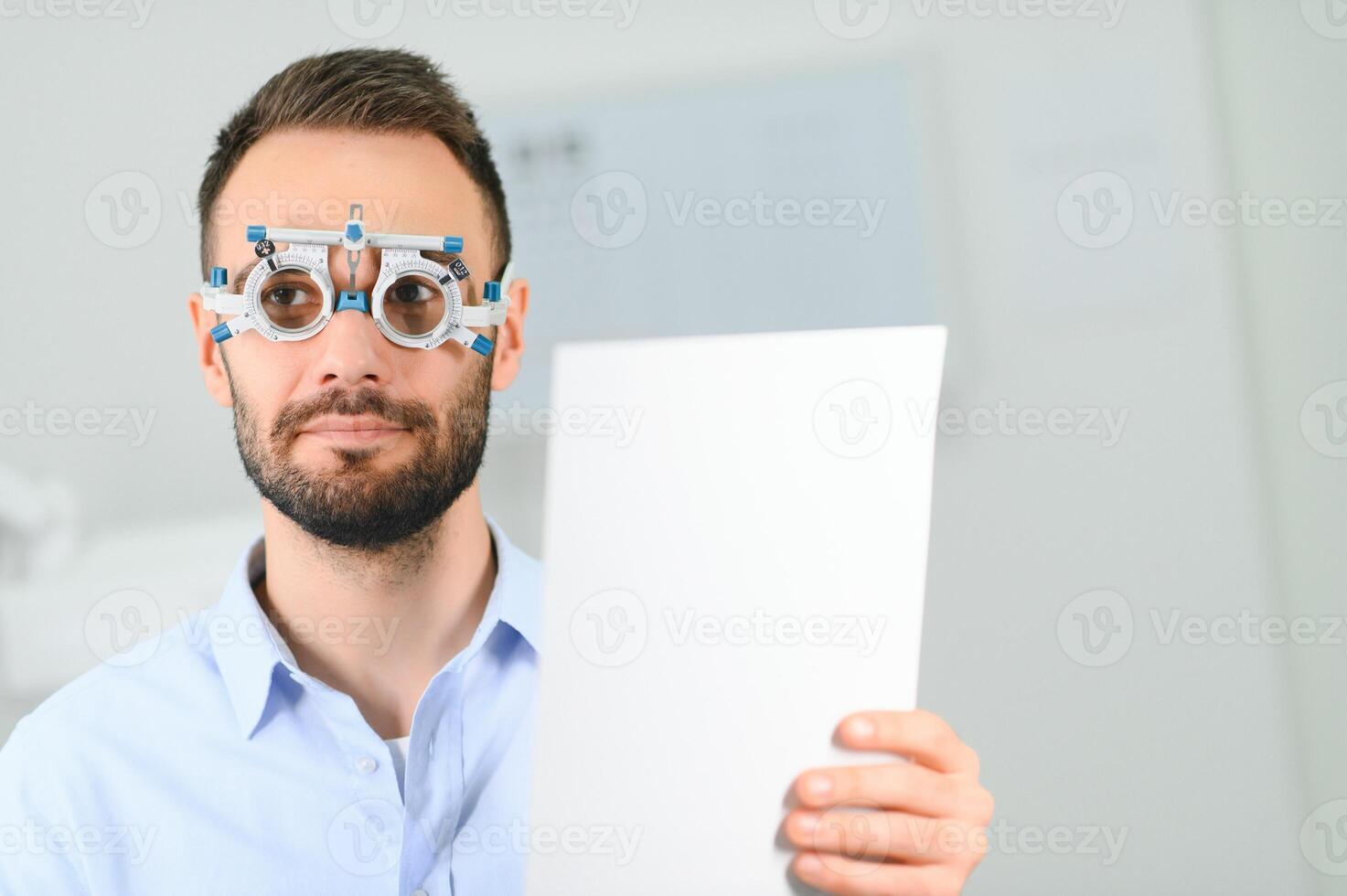 Ophthalmology concept. Male patient under eye vision examination in eyesight ophthalmological correction clinic photo