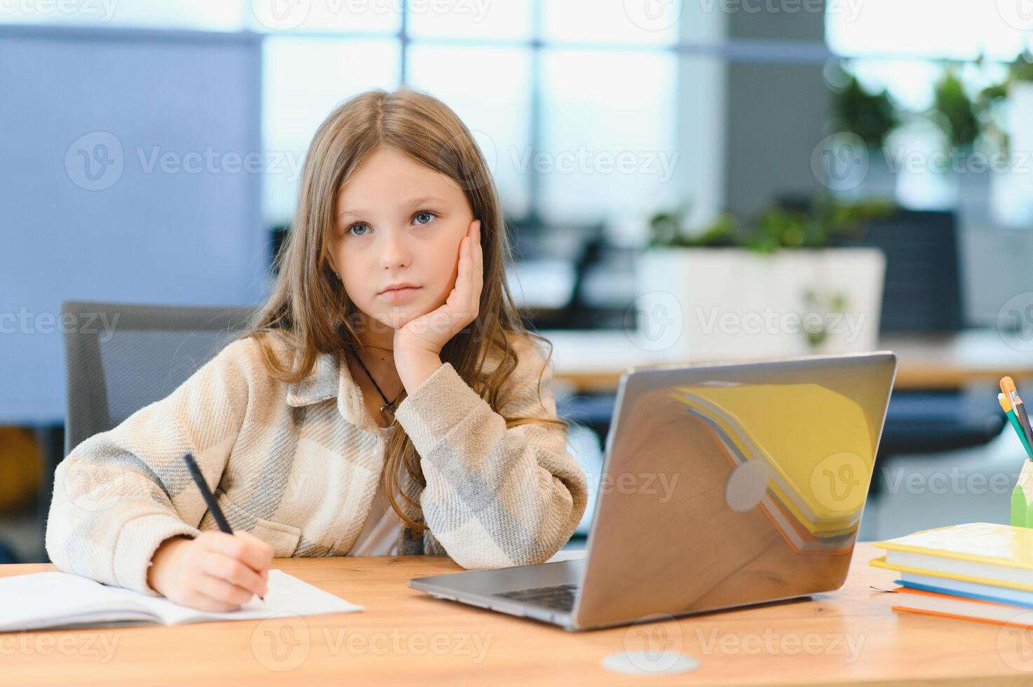 Smiling little Caucasian girl have video call distant class with teacher photo