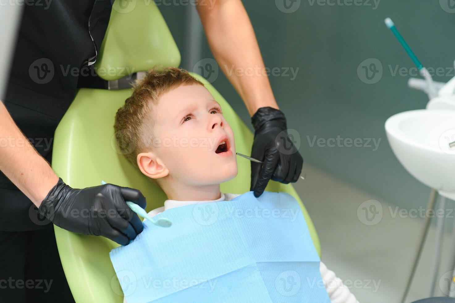 Scared red-haired boy crying at reception at dentist in dental chair. Pediatric dentistry photo