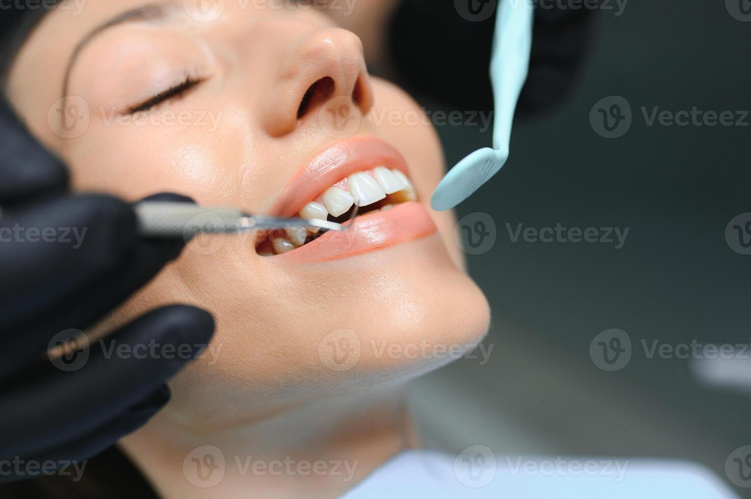 Dentist examining a patient's teeth in the dentist photo