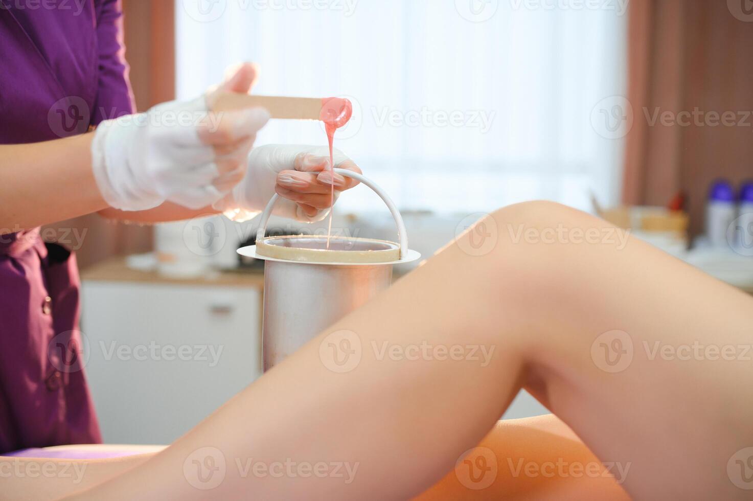 Sugaring epilation with liquate sugar at legs photo