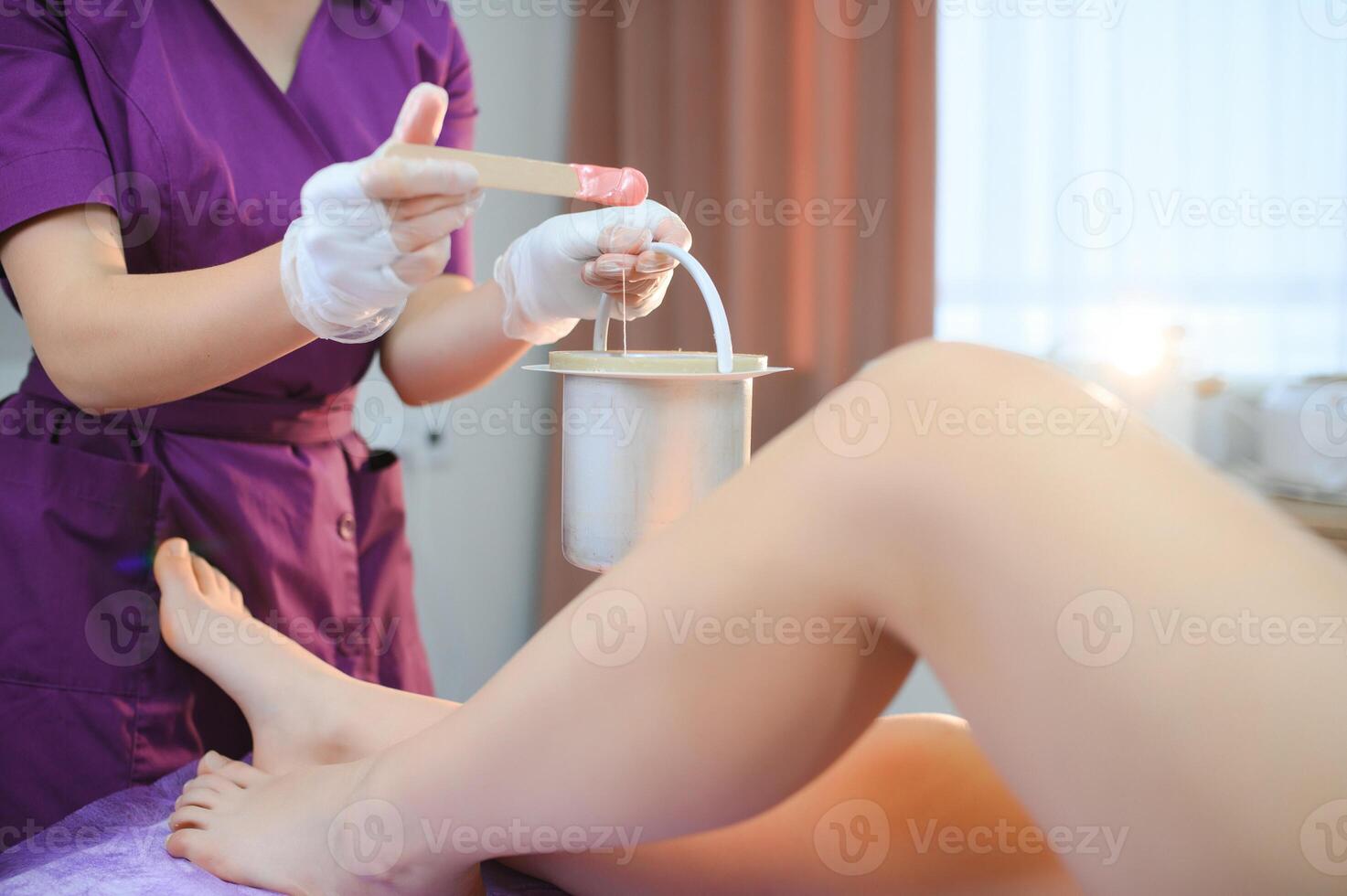 Sugaring epilation with liquate sugar at legs photo