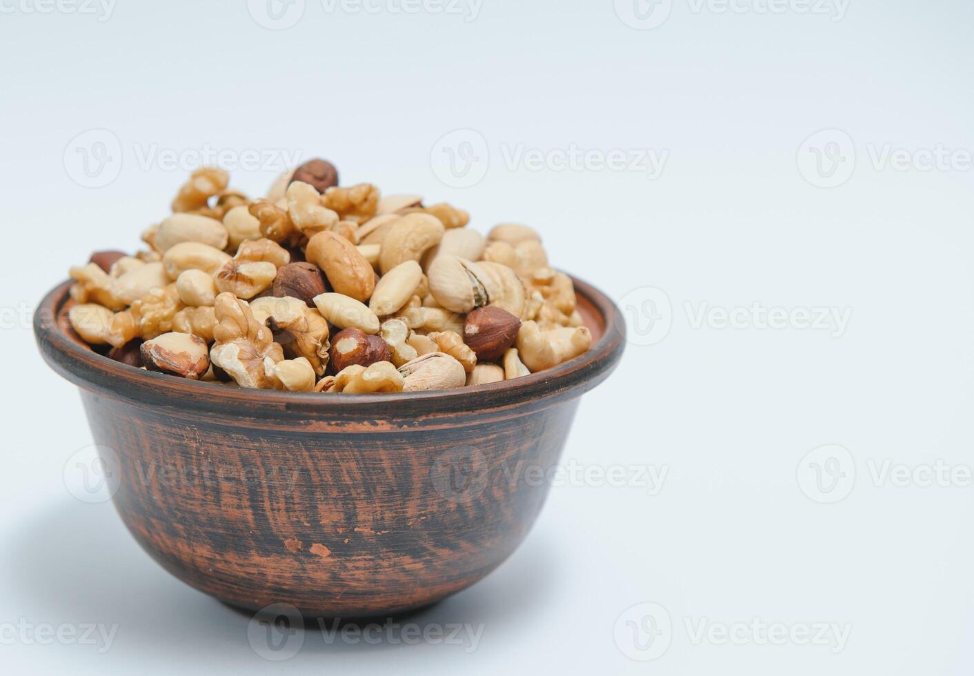 Various nuts on a plate, top view. photo