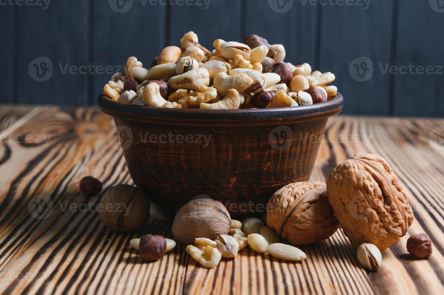 Mixed nuts on wood floor. Organic and fresh nuts. Copy space photo