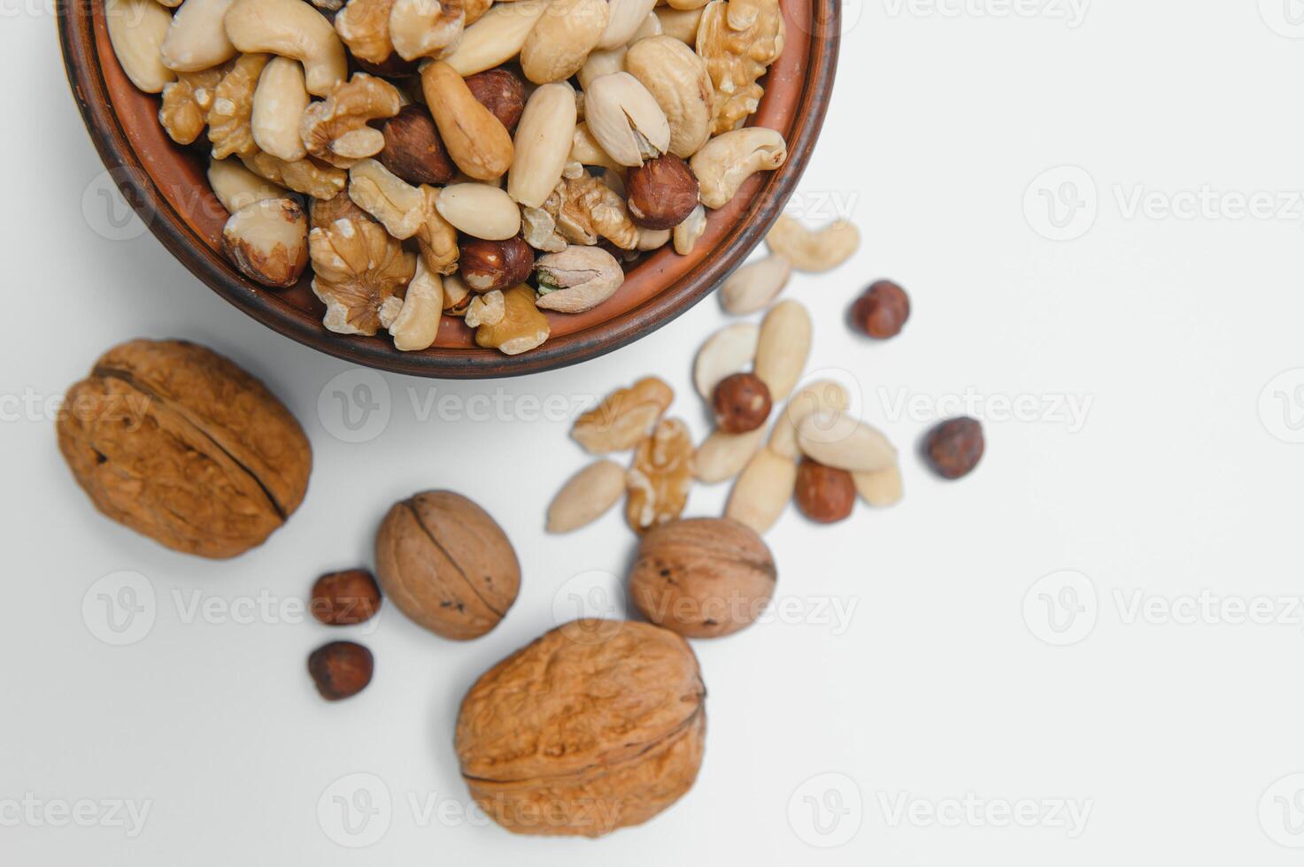 Various nuts on a plate, top view. photo