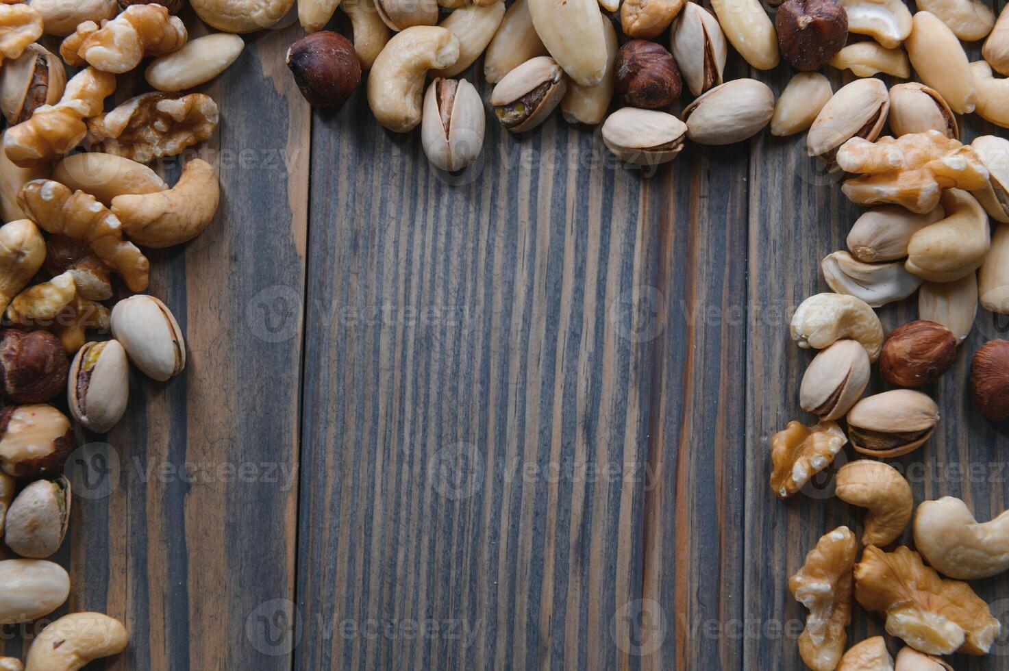 Mixed nuts on wood floor. Organic and fresh nuts. Copy space photo