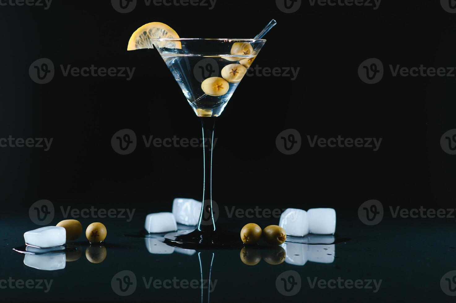 Drink martini. Martini with olives on a black table. Free space for text. photo