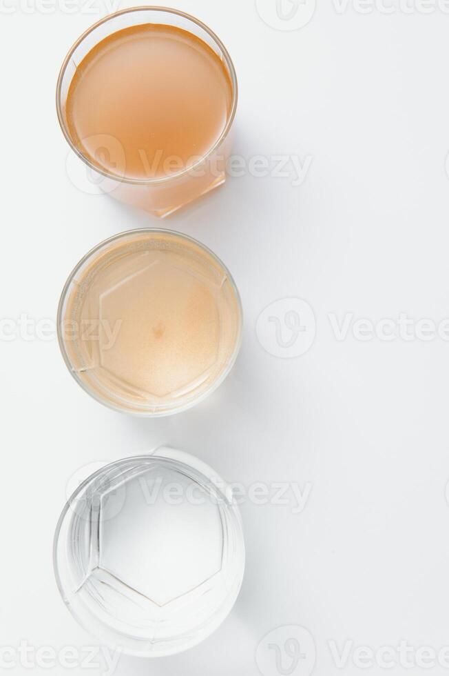 Water filters. Concept of three glasses on a white background. Household filtration system. photo