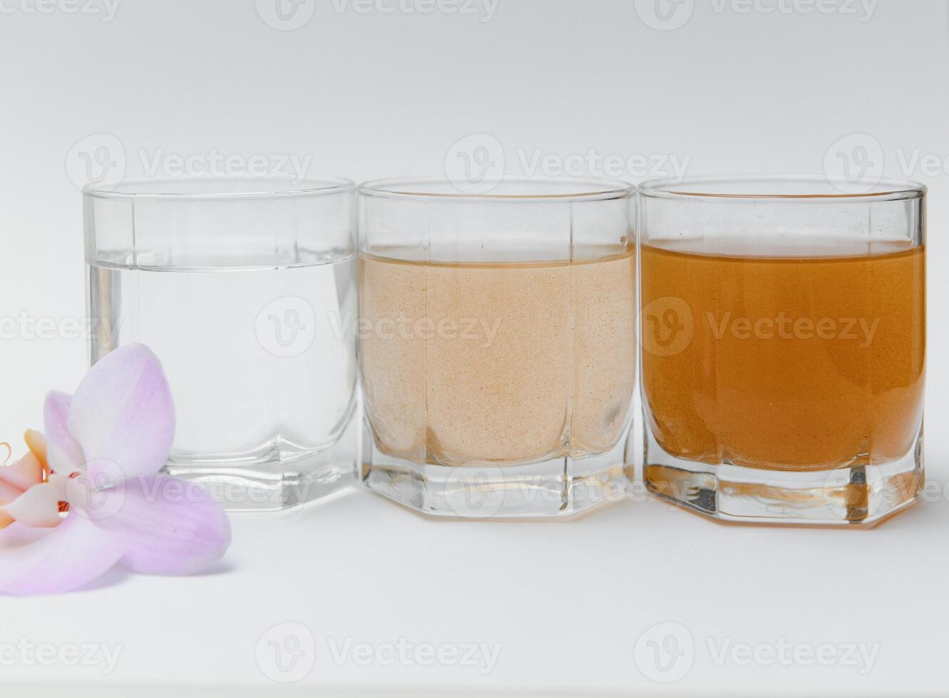 Water filters. Concept of three glasses on a white background. Household filtration system. photo