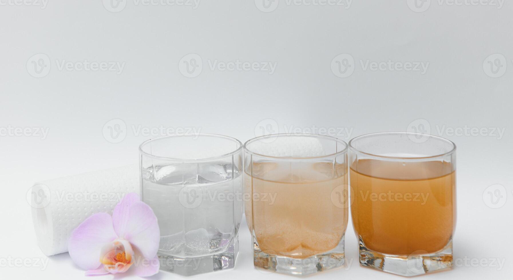 Filter system for water treatment with glasses of clean and dirty water on bright background photo